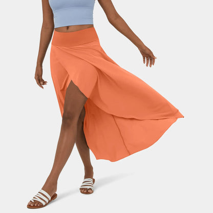 Libra | Elegante Gespleten Maxi Rok - Voeg stijl en comfort toe aan je garderobe met de Libra maxi rok. Ideaal voor elk seizoen dankzij het high-low ontwerp, ruches voor extra volume, en een elegante maxi-lengte. Perfect voor kantoor, avondjes uit of casual dagen. Gemaakt van duurzaam polyester in diverse kleuren: Khaki, Oranje, Roze, Blauw, Vermiljoen en Wijn. Verkrijgbaar in maten XS-XL. Upgrade je looks met deze tijdloze must-have!