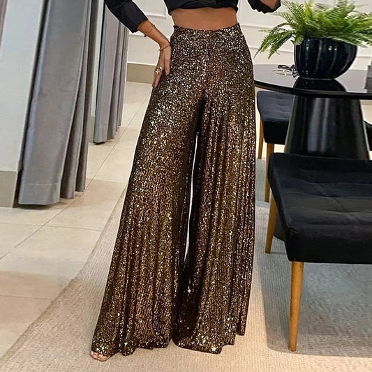 Rosalinde wide-leg broek: stijlvolle broek met schitterend paillettenontwerp, high-waisted pasvorm en vloeiend silhouet. Perfect voor avondfeesten, evenementen en feestelijke gelegenheden. Verkrijgbaar in Donkerbruin, Zwart en Zilver, in maten S t/m 5XL. Combineer glamour en comfort met de Rosalinde en laat je outfit stralen. Bestel nu en voeg een vleugje sprankeling toe aan je avondgarderobe!
